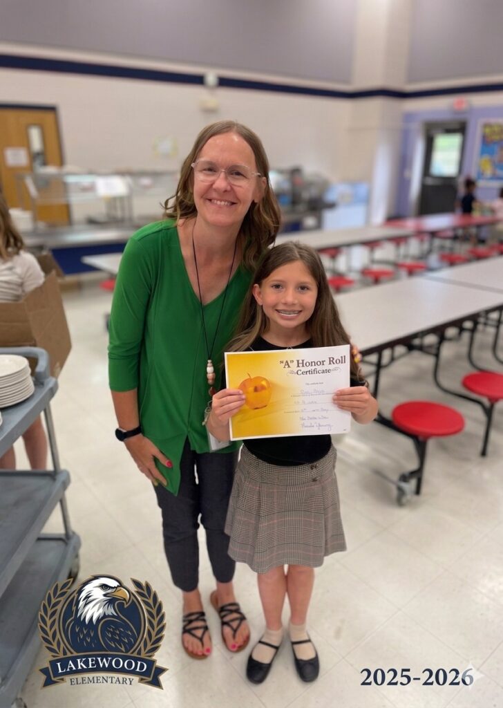 Poppy Mixon with her teacher Ms. Amanda holding her A Honor Roll certificate
