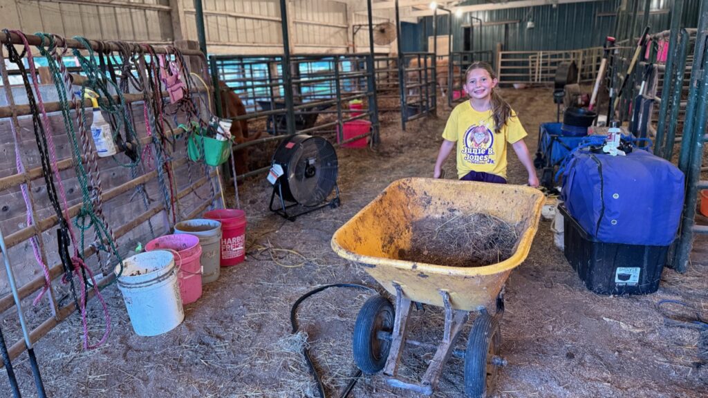 Poppy Mixon doing evening barn chores in her Junie B. Jones Jr. cast shirt