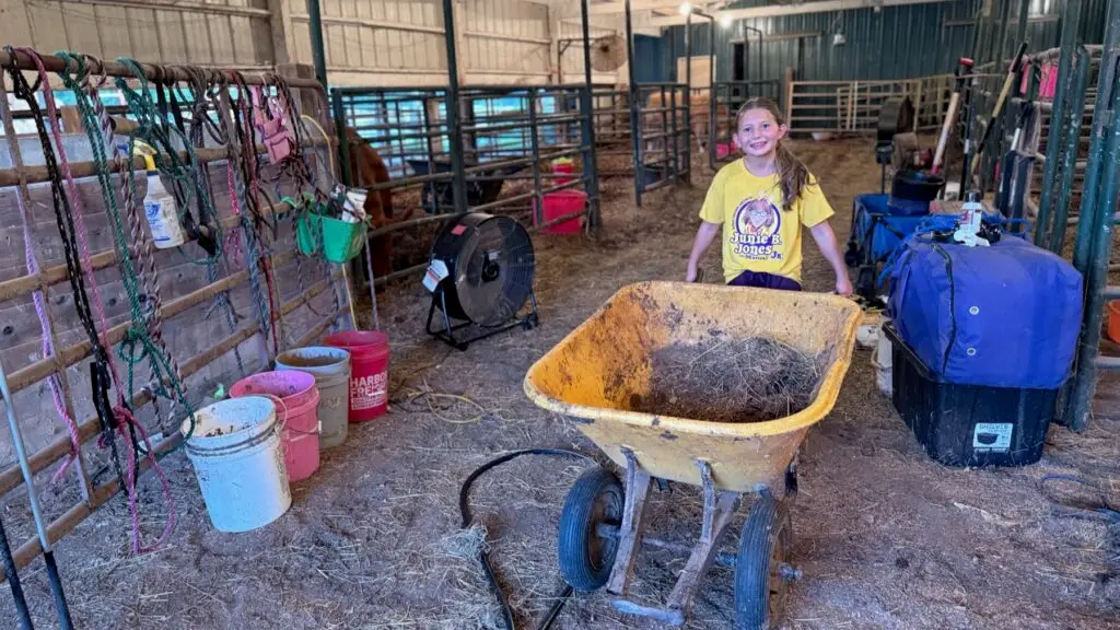 Poppy Mixon doing evening barn chores in her Junie B. Jones Jr. cast shirt