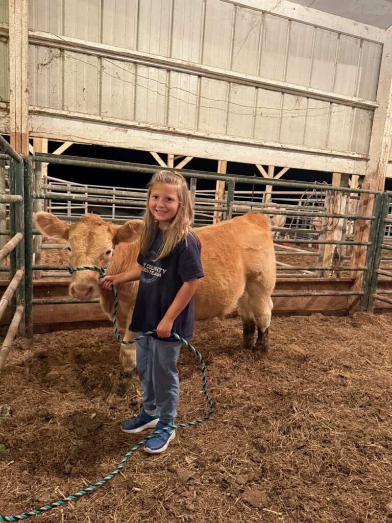 Poppy Mixon and Mr. Moo-agi on the farm
